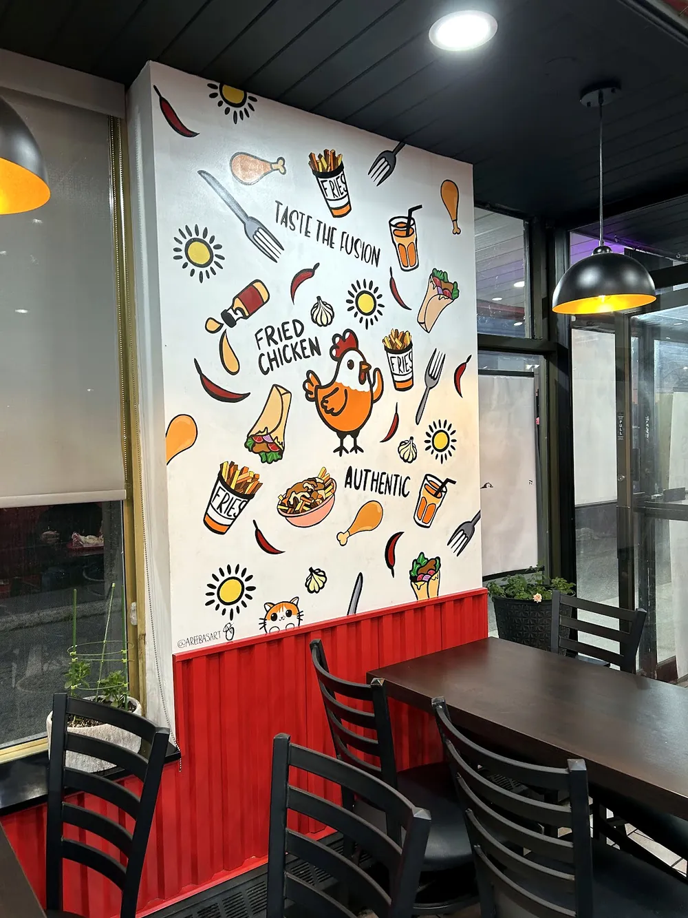 Inside AL Chick with the chicken mural